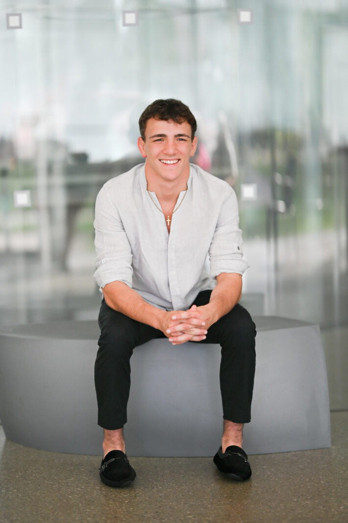 Jeremy, a Wheeling University student preparing for a career in law enforcement, smiling confidently on campus.